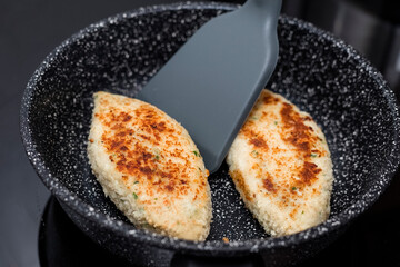 Fried chicken cutlets on a pan. Cooking. Close-up