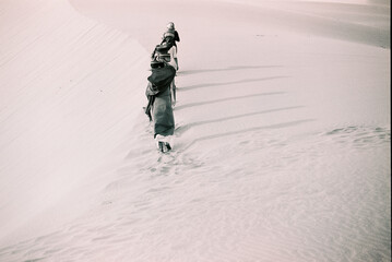 Black and white landscape photo film: girls in Nam Cuong sand dunes. Time: Saturday afternoon,...