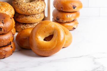 Stacks of Various Flavors of Bagels on a Counter