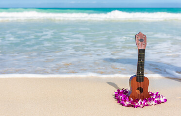 Ukulele and lei flower necklace on Hawaii beach. Hawaiian travel icons for tourism vacation...
