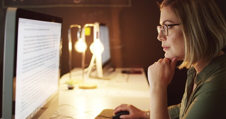 Late nights are a part of the path to success. 4k video of a young businesswoman working late on a computer in an office.