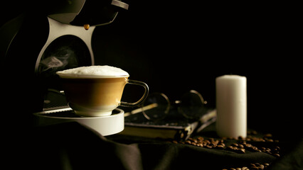 A mug of Cappuccino is in the coffee maker and coffee drips into the mug. Home professional coffee machine with a coffee cup.