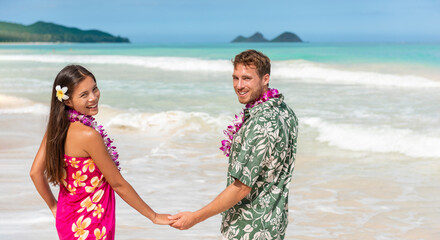 Hawaii couple in hawaiian shirt and lei flowers dress woman walking on beach for wedding honeymoon banner panoramic. Happy Asian girl and man lovers holding hands on travel vacation. - obrazy, fototapety, plakaty