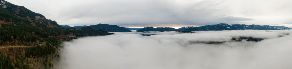Fototapeta na wymiar Aerial Panoramic View of Canadian Mountain Landscape covered in fog over Harrison Lake. Winter Season. British Columbia, Canada. Nature Background Panorama