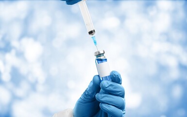 Doctor with syringe and vial of the vaccine for new Covid-19 Omicron
