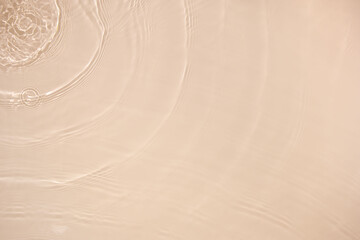Transparent beige clear water surface texture with ripples, splashes and bubbles. Abstract nature...