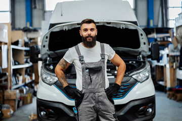 Portrait of happy auto mechanic at workshop.