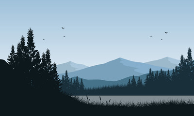 Beautiful view of the mountains by the lake with the silhouette of the pine trees around it