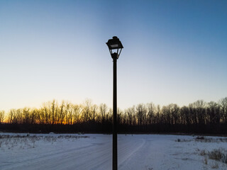 Lamp post alone in winter sunset