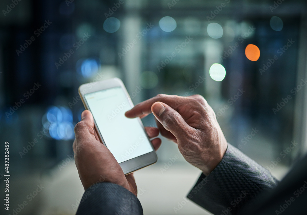 Aufkleber getting business updates via texts. cropped shot of a businessman using a mobile phone in a modern o