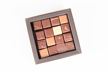 Assortment many small square fine chocolate candies in gift sqare open box