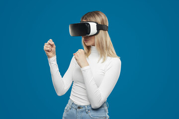 Woman playing videogame in VR glasses