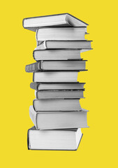 Big books pile at yellow background. Education, reading literature concept. High quality photo