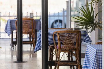 Atmospheric summer photography. Wooden cafe chairs  on table. indoor street cafe