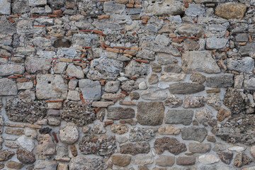The texture of the stone wall. Background texture of the stone wall of the old castle.