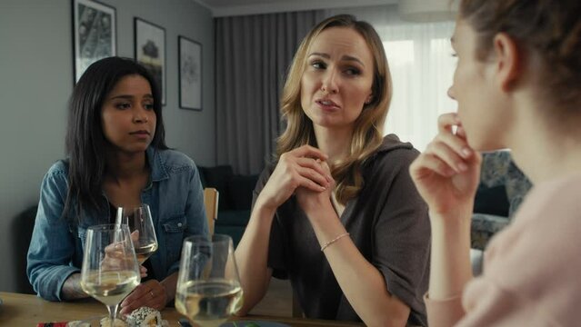 Three female caucasian and mixed race friends chatting over problems at home. Shot with RED helium camera in 8K   