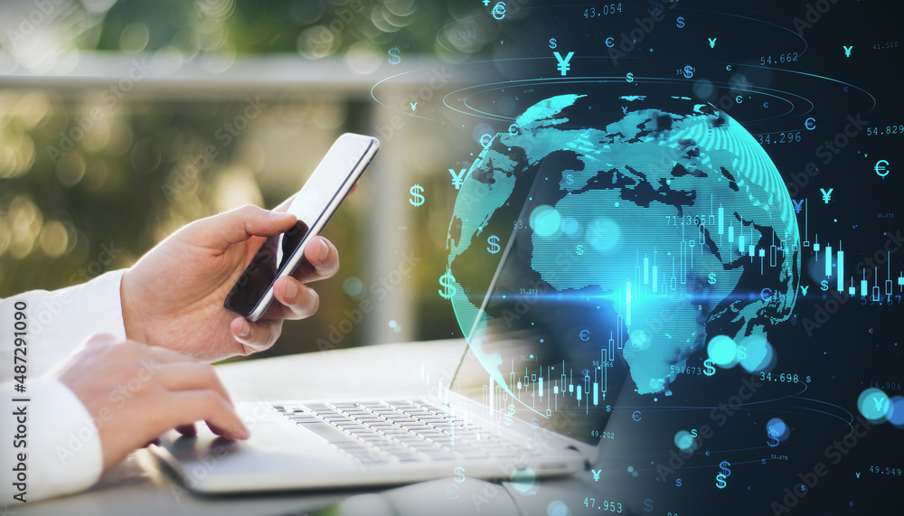 Poster close up of businessman hands using laptop computer and smartphone with glowing money transfer globe