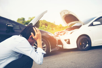 Young man rubbing neck in pain from whiplash injury standing by damaged car after traffic...