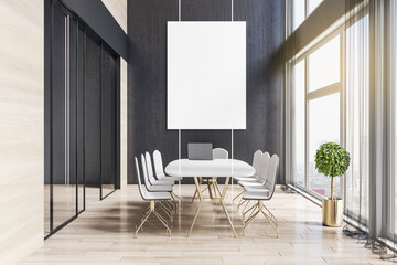 Front view on modern sunny meeting room with light stylish furniture, golden table legs, tree pot near huge window, wooden floor and blank white poster on dark wall. 3D rendering, mockup
