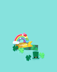 happy greeting card, decorative clover leaves, toy rainbow and leprechaun hat on abstract green...