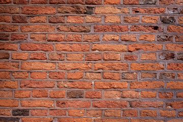 Old brick wall background, brick wall texture. Old broken brick, cement joints, closeup. crumbles with age.