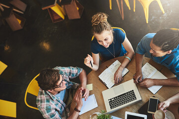 We have everything we need to pass. High angle shot of a group of students studying in a coffee...
