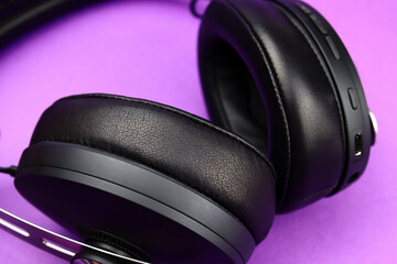Fototapeta na wymiar Full-size wireless headphones close-up on a purple background