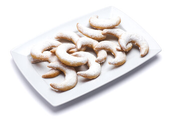 Traditional German or Austrian Vanillekipferl vanilla kipferl cookies on a plate isolated on white background