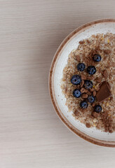 cereal porridge with blueberries and chocolate for breakfast