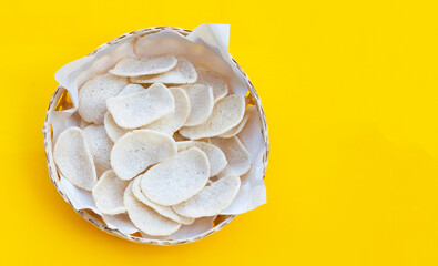 Prawn crackers on yellow background. Shrimp crispy rice snack