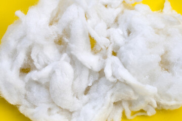 Polyester stable fiber on yellow background.