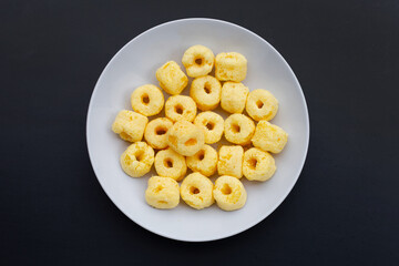 Roller corn snack on dark background
