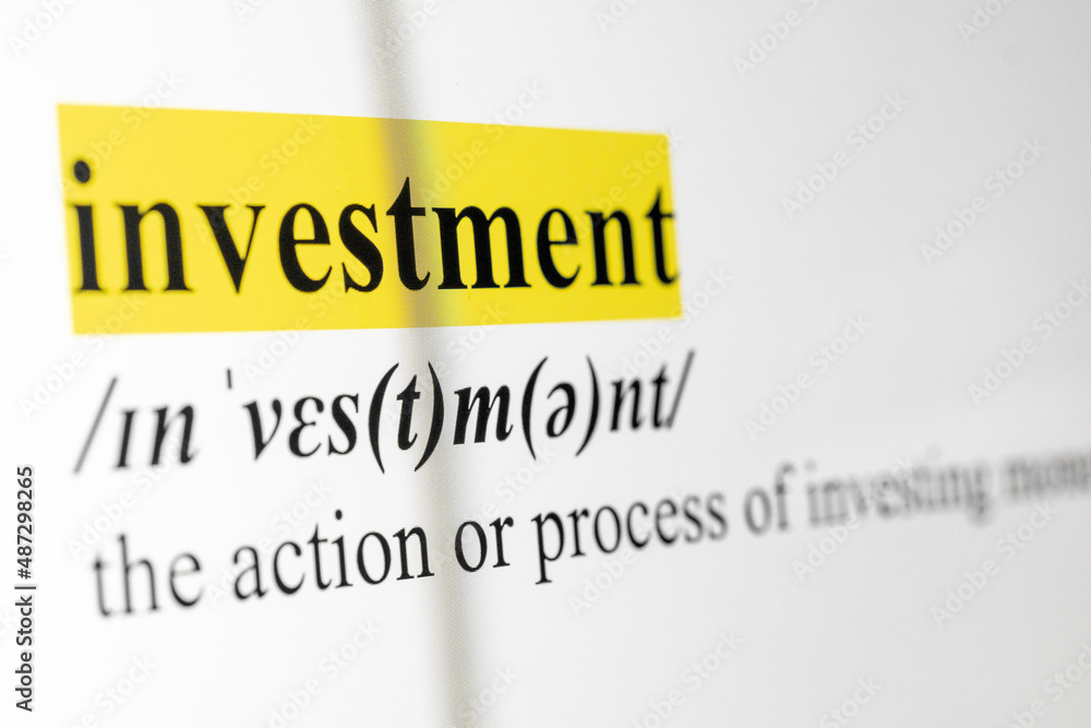 Poster investment text macro shot highlighted in yellow color on computer screen