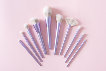 Professional make up tools brushes on a pastel pink background. Set of glamour make up brushes. Magazines, social media. Visagist tools. Top view. Creative flat lay. Cosmetics products