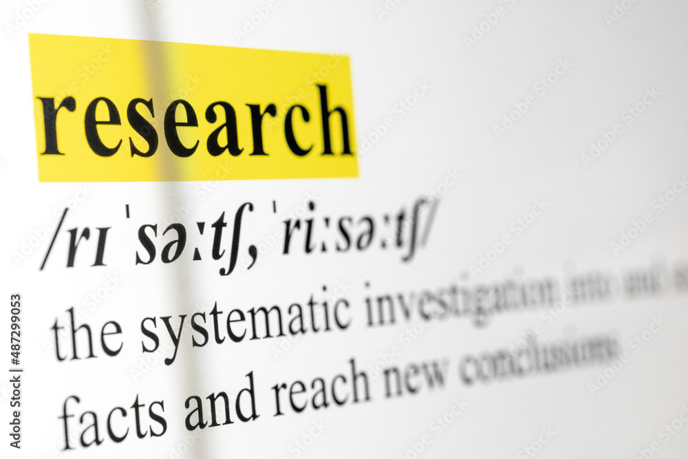 Poster research text macro shot highlighted in yellow color on computer screen
