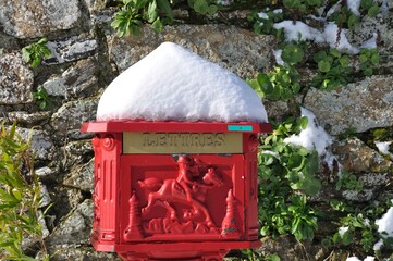 Vintage red mailbox under the snow