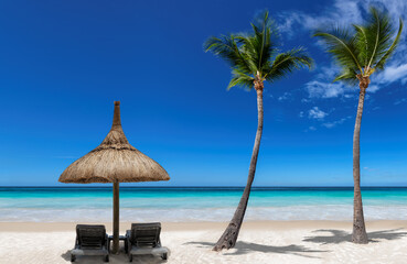 Chairs and umbrella in sunny tropical Palm Beach and turquoise sea. Summer vacation and tropical beach concept.	