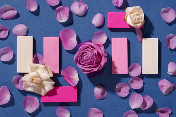 Roses creative composition blue background. Top view of roses buds petals. Original vertical greeting card for Mother's Day, International Women's Day, Valentine's Day, wedding. Women's beauty concept