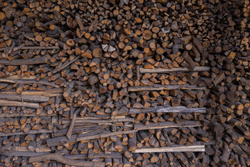 Stacked Firewood. Wooden grunge background made with wood cross sections. Natural wood log texture, wall decor. Mass of wood logs forest tree ecology industry.