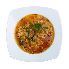 Soup of cabbage Shchi with pork and vegetables, served in bowl. Isolated over white background