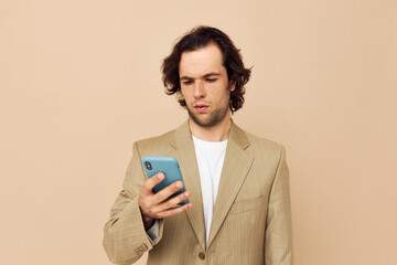 handsome man takes a selfie classic style technologies beige background