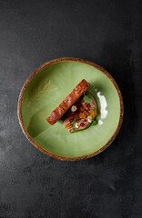 Chicken liver pate with artisan bread in green handmade ceramic plate. Appetizer from liver with...
