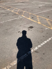 Shadow of a man on a car park. 