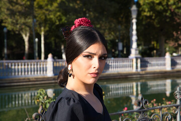Flamenco dancer woman, brunette and beautiful dressed in typical black costume with yellow polka...