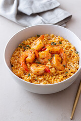 Risotto with shrimps, tomatoes and thyme. Italian food.