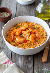 Risotto with shrimps, tomatoes and thyme. Italian food.