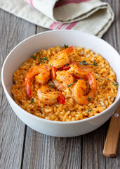 Risotto with shrimps, tomatoes and thyme. Italian food.