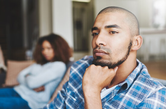 Dont Talk To Me. Shot Of A Young Man Looking Upset After A Fight With His Wife In The Background.