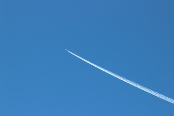 Flying plane against the blue sky as a background.