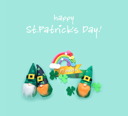 Cute irish gnomes, decorative clover leaves and toy rainbow on abstract green background. happy...